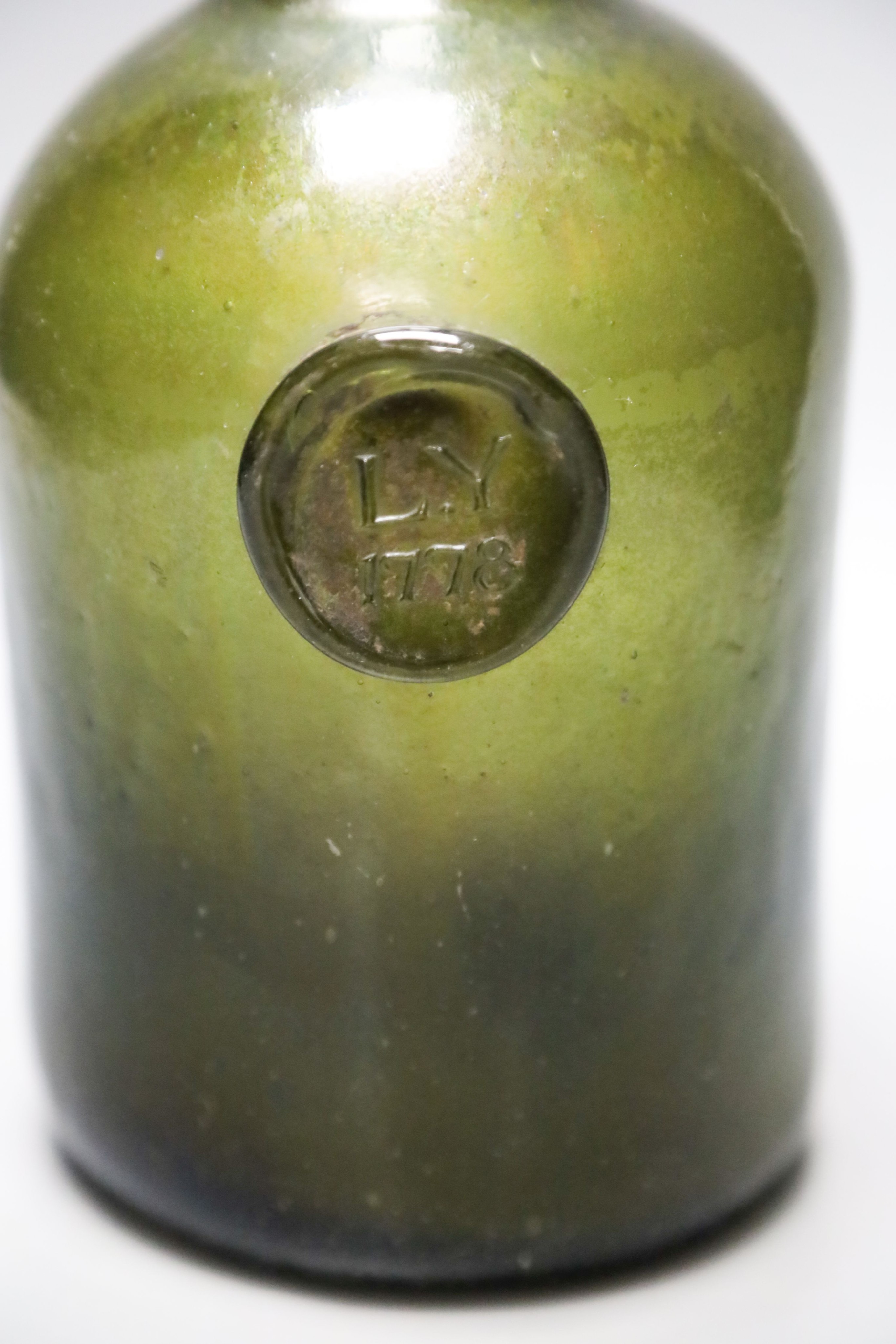 A George III green glass sealed wine bottle, dated 1778 26cm